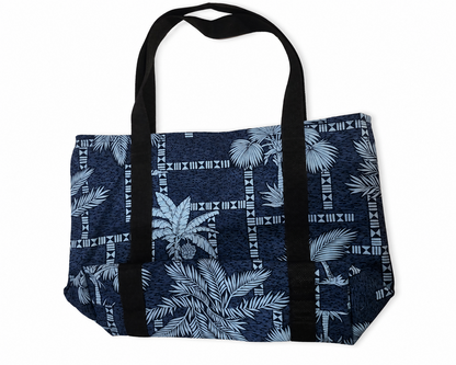 A navy blue tote bag with a white tropical palm leaf and tribal geometric pattern, featuring black webbed handles, shown on a plain white background.
