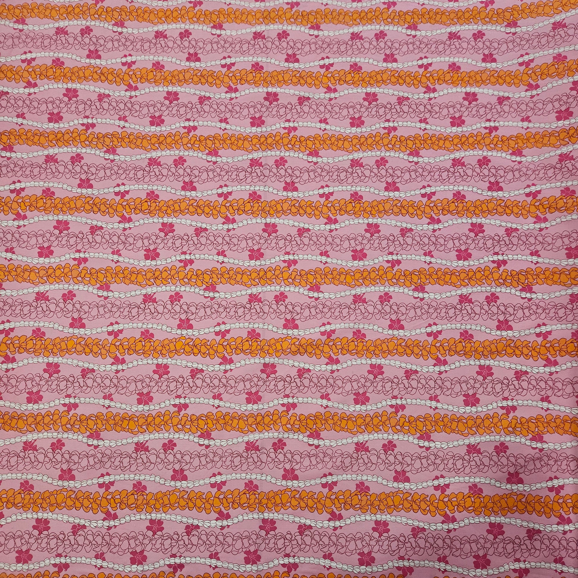 Patterned floral fabric with vertical floral stripes on a pink background