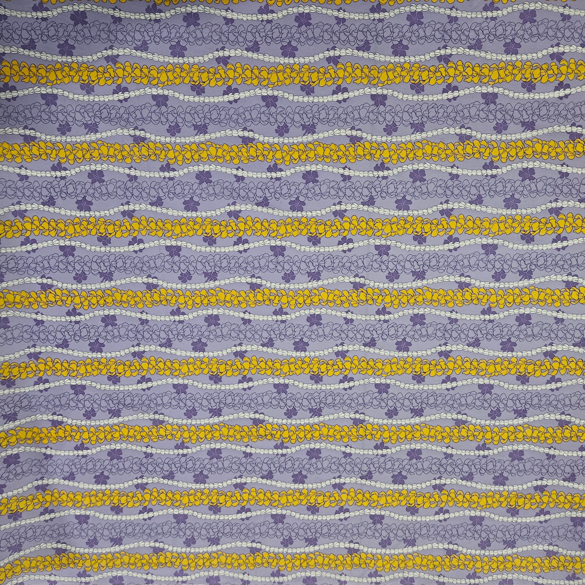Patterned fabric with blue and yellow floral stripes on a purple background