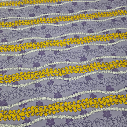 Patterned fabric with yellow and white floral designs on a purple background