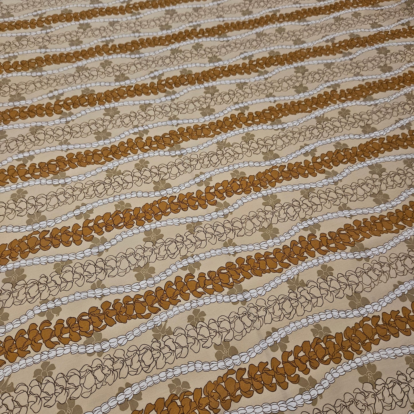 Textured fabric with wavy brown and beige floral pattern
