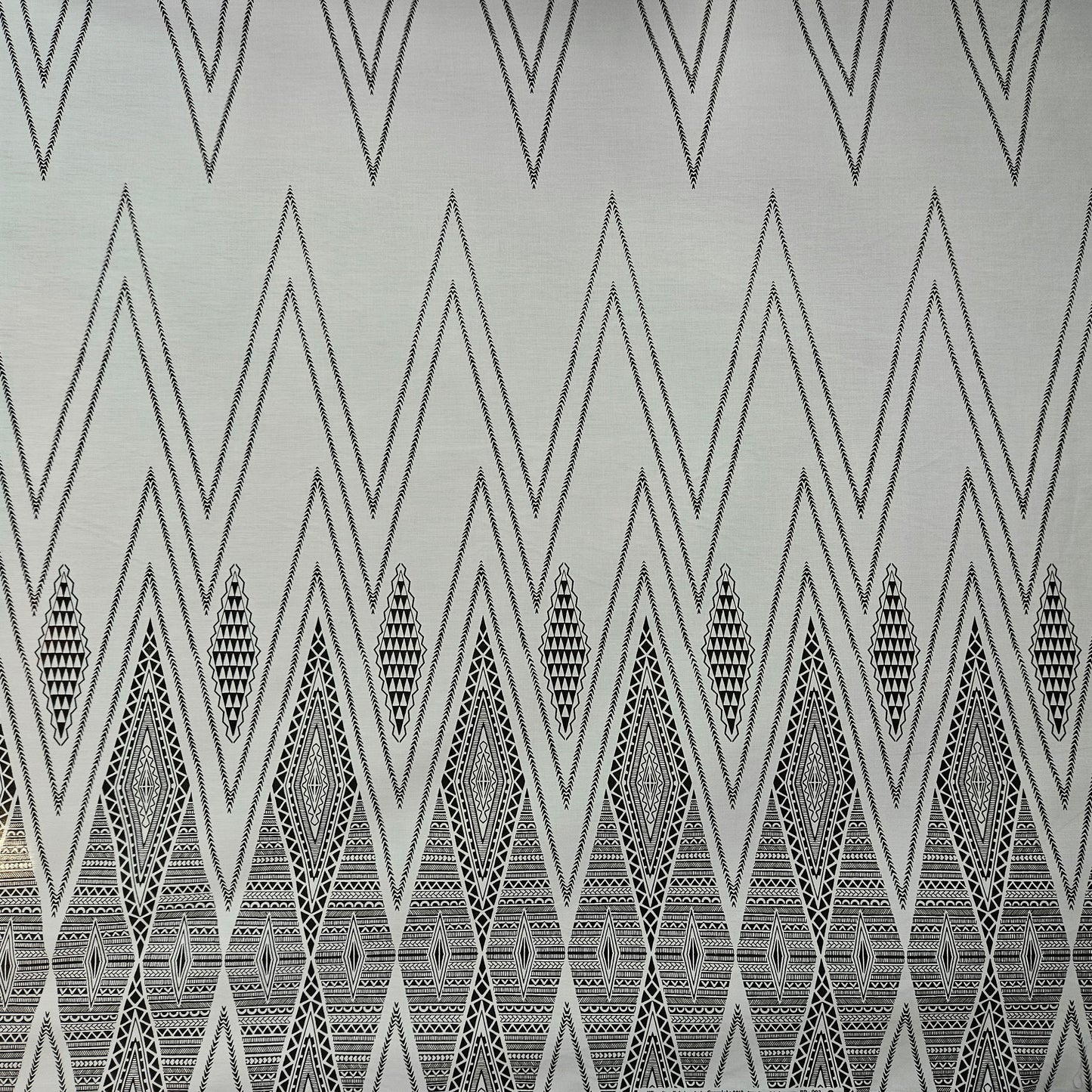Pattern of black and white triangles on a textured surface.