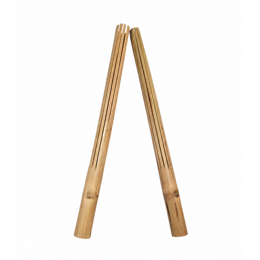 A pair of natural bamboo puili sticks arranged in a V-shape on a plain white background.