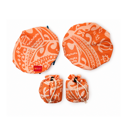 Three orange and cream patterned round fabric items with drawstring pouches, arranged on a white background. A small red label is visible on the left pouch.